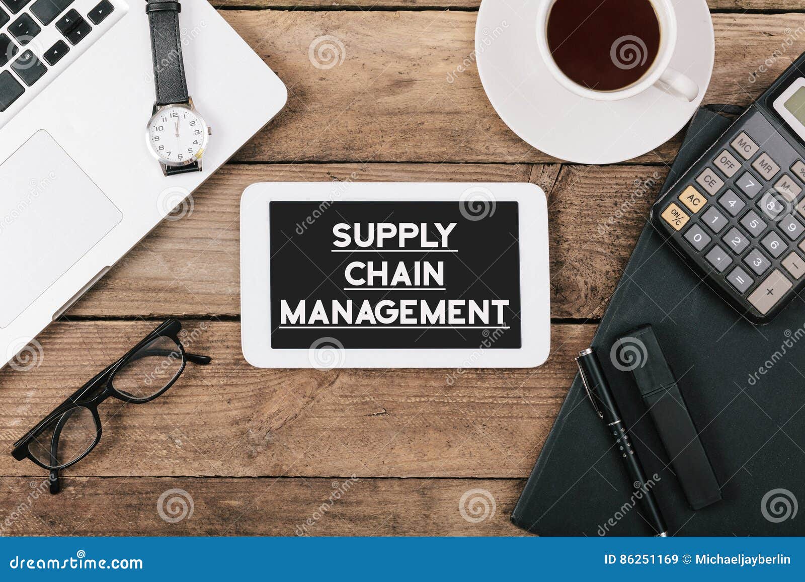 text supply chain management on screen of table computer at office desk